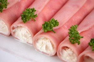 Rolled ham filled by cream with horseradish